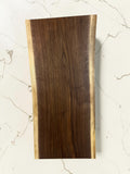 36 inch live-edge walnut charcuterie board  board displayed on a white marble surface.