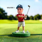 A golfer stands on a green circular base on a golf course. The golfer wears a navy cap with a white logo, a red polo shirt, white shorts, and white shoes, and is swinging the golf club up. Style Golfer 1.