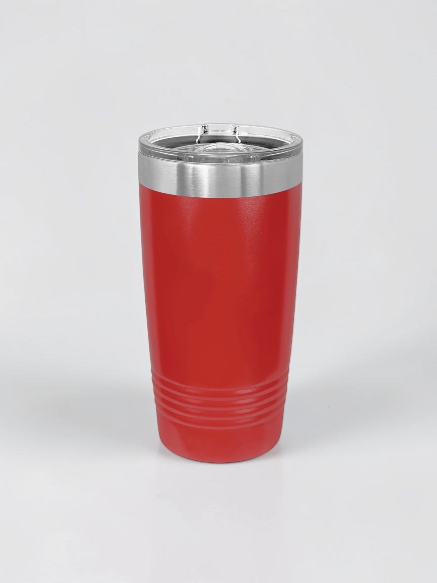 A red insulated travel tumbler with a stainless steel rim and a clear plastic lid, shown on a light gray background.